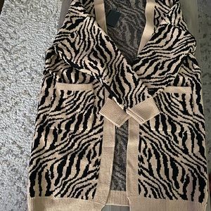 Zebra print long sleeve cardigan. The bottom hits knees.